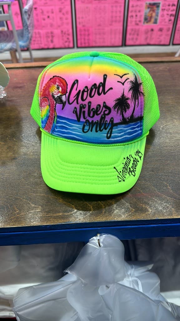 Neon green trucker hat with Good Vibes Only beach airbrush design